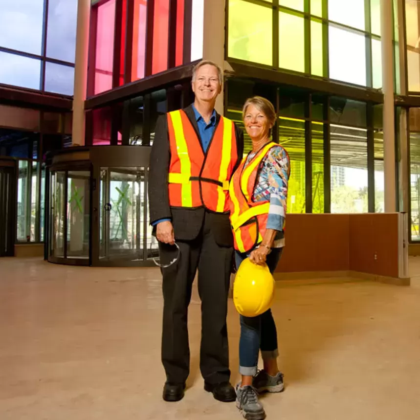 bob and deb peacock standing in front of building